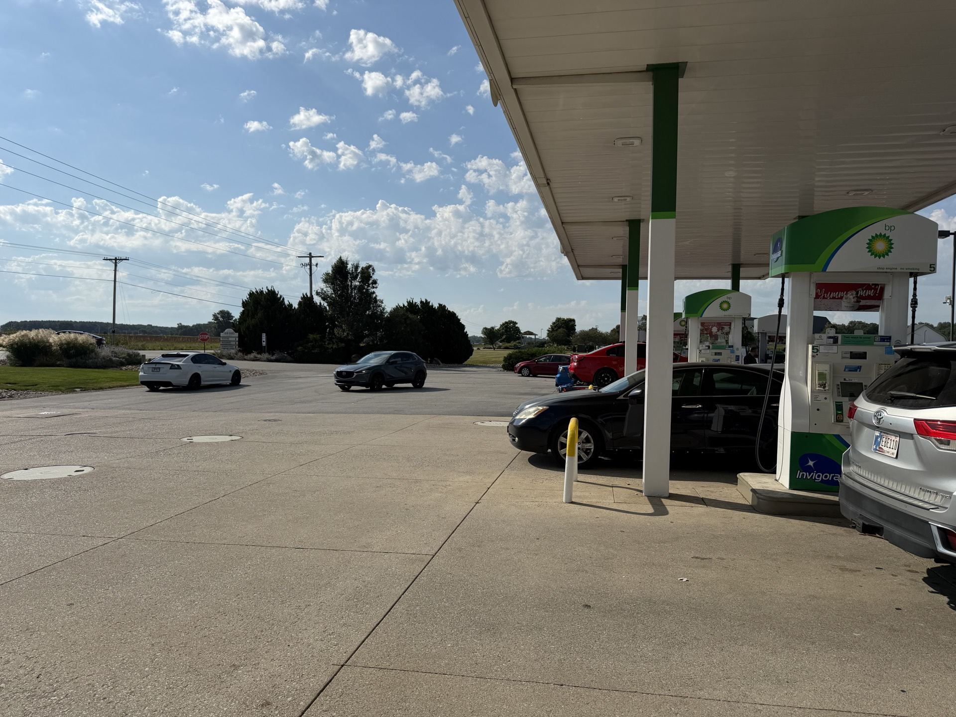 Wide shot of the gas station stop with Holdens fueling up before the drive to IMS