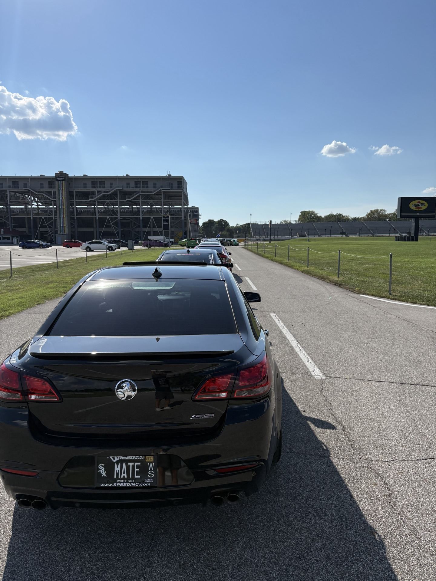 2017 Chevy SS with MATE license plate parked beside the road course